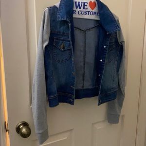 Denim jacket with gray sweatshirt sleeves and hood